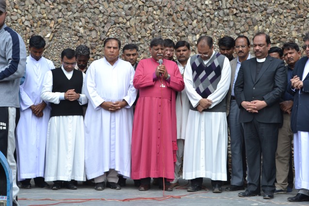 The Right Reverend Irfan Jamil prays for the deceased and injured following the suicide attack on two churches.  Credit. Pukaar News