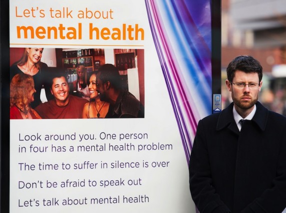 Councillor Rory palmer stands next to one of the posters. Credit. Leicester City Council